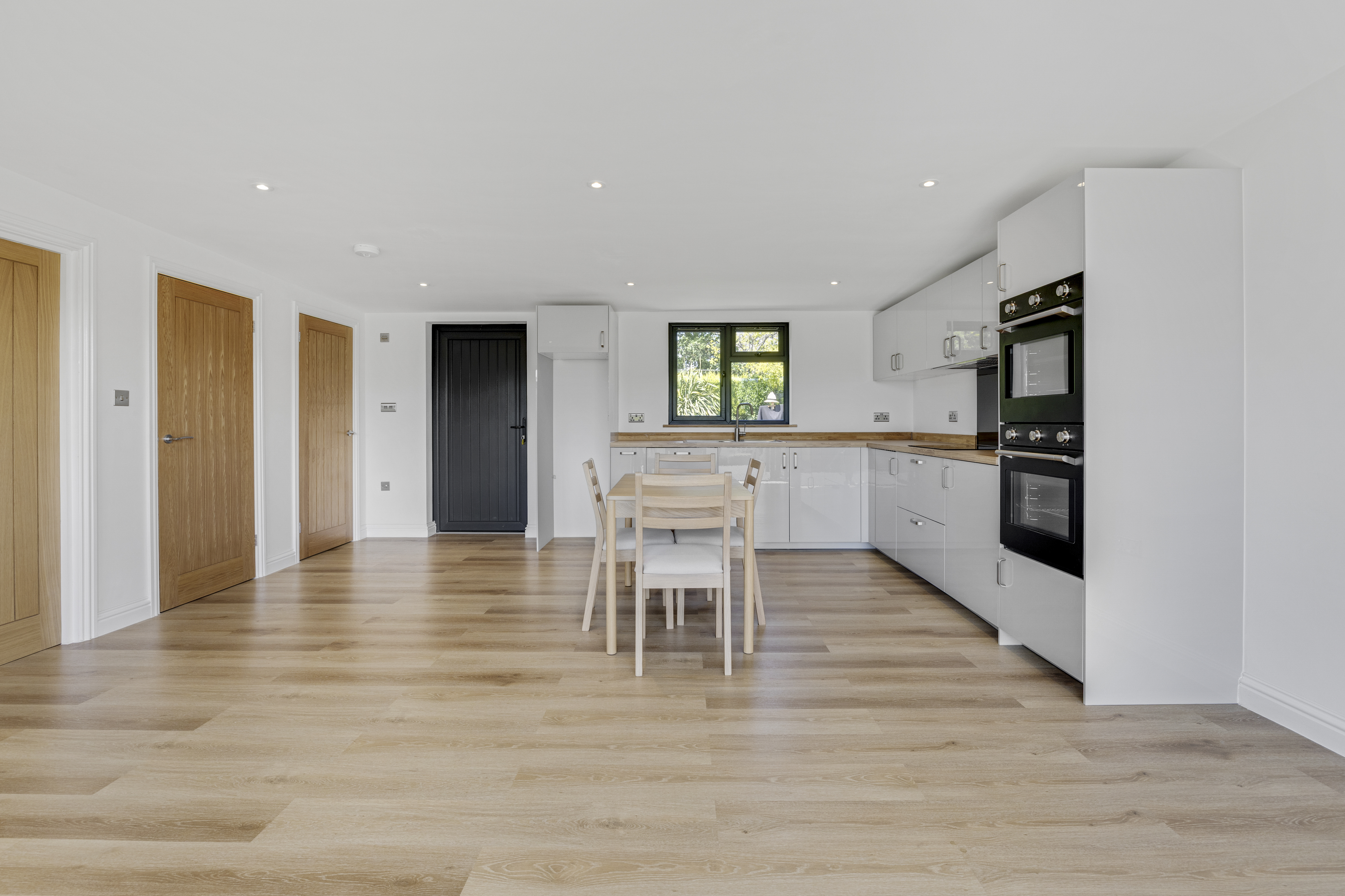 Bespoke garden annexe Interior Design with modern appliances and clean worktops