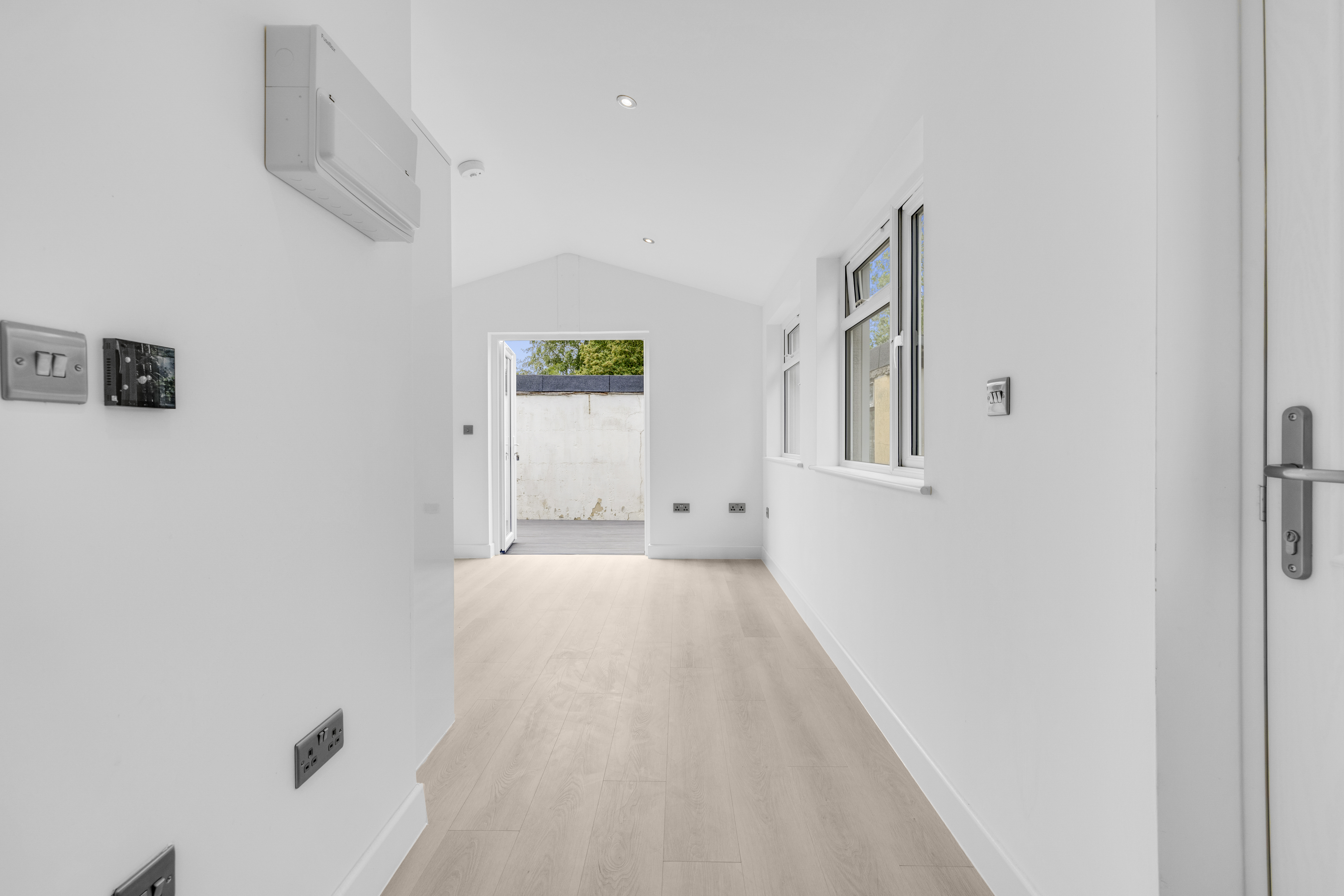 Bespoke garden annexe Interior Design with modern appliances and clean worktops