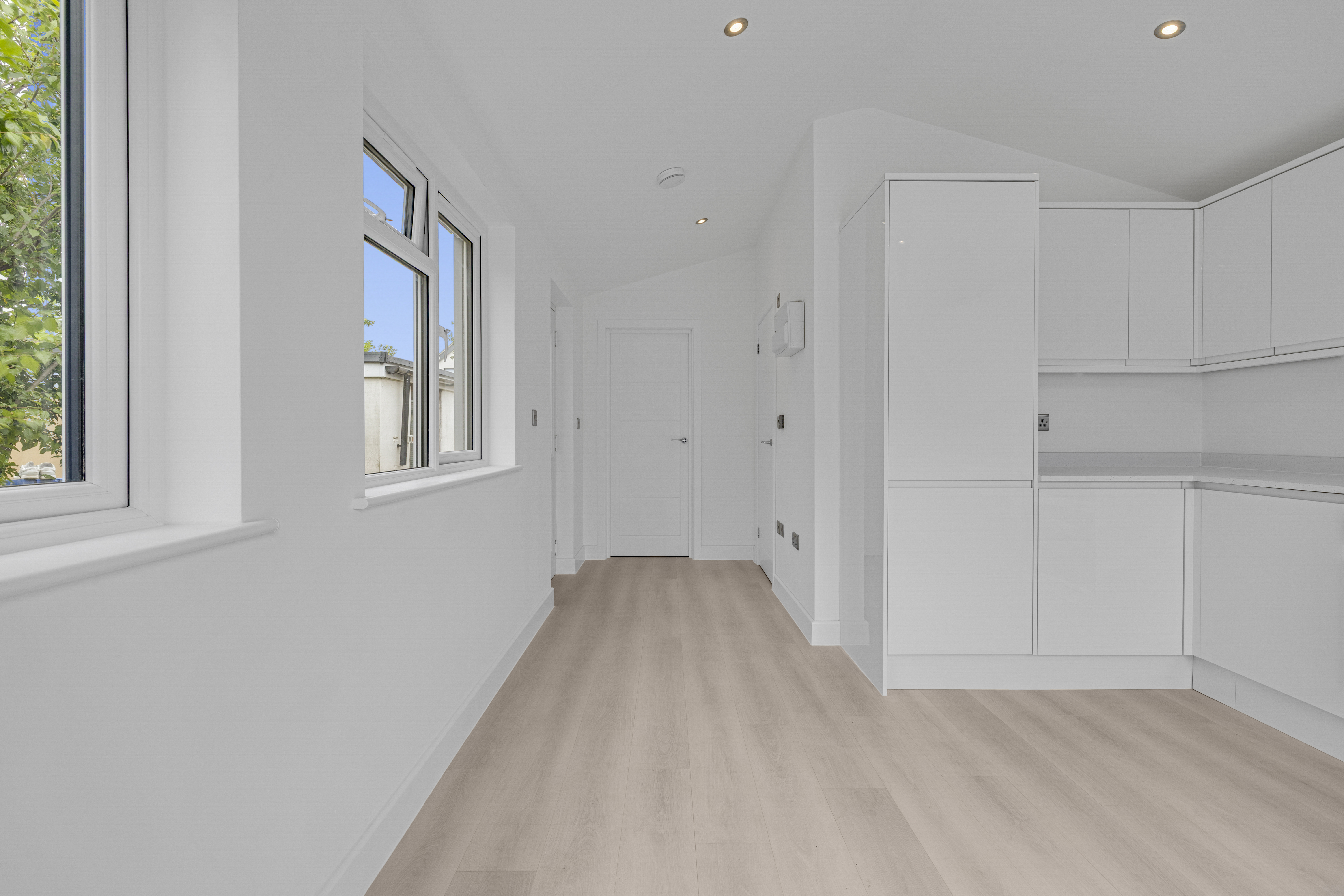 Bespoke garden annexe Interior Design with modern appliances and clean worktops