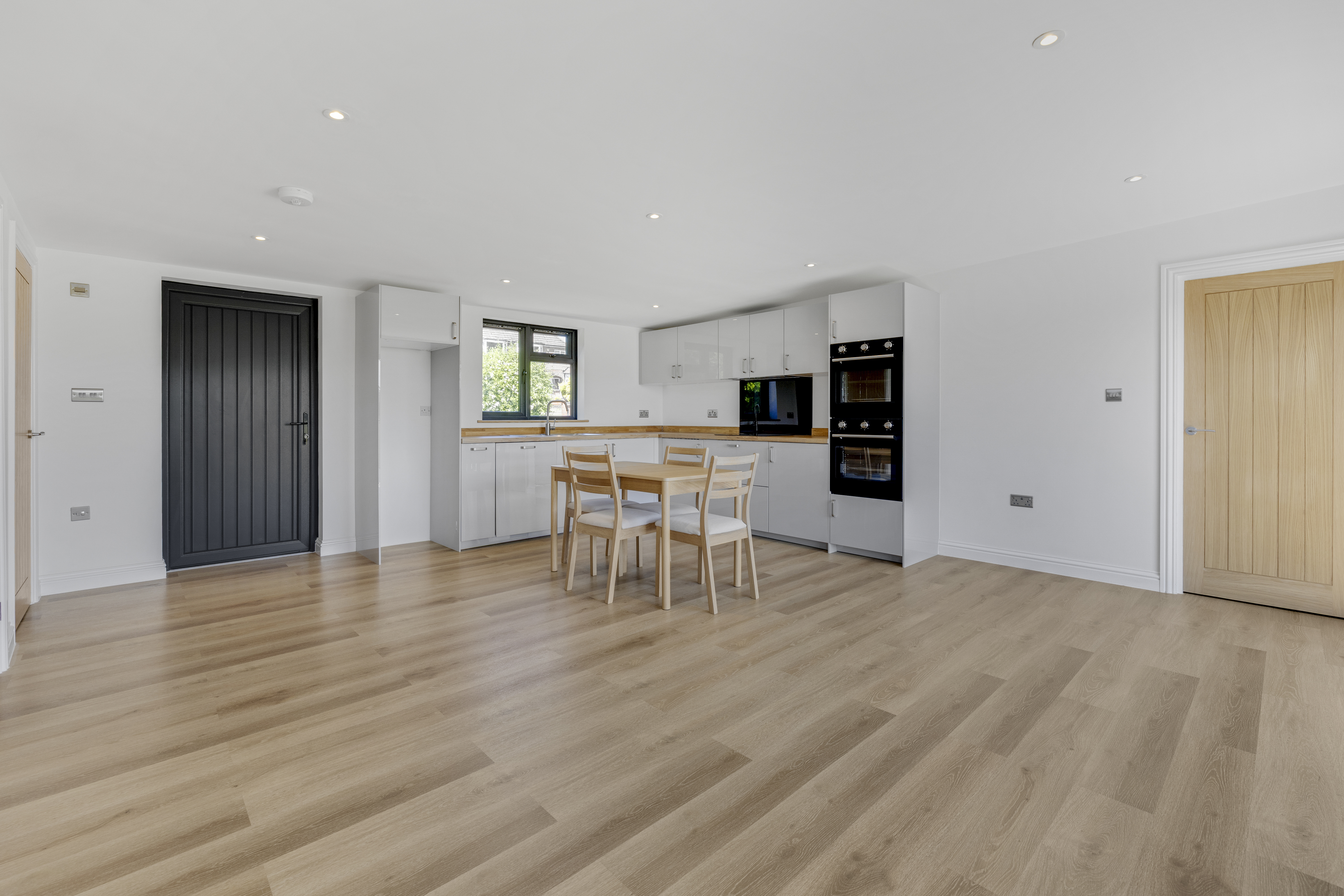 Bespoke garden annexe Interior Design with modern appliances and clean worktops