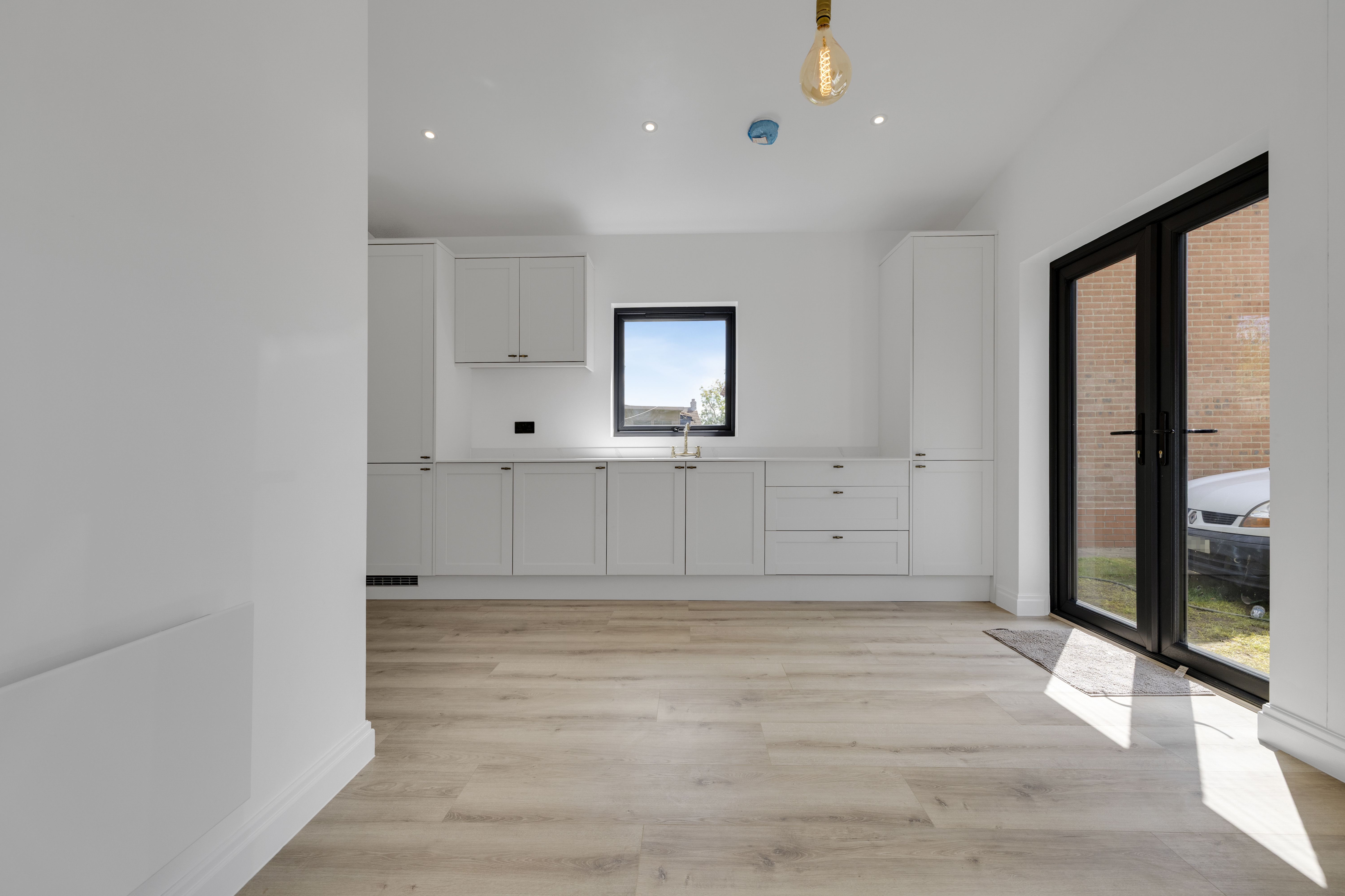 Bespoke garden annexe Interior Design with modern appliances and clean worktops