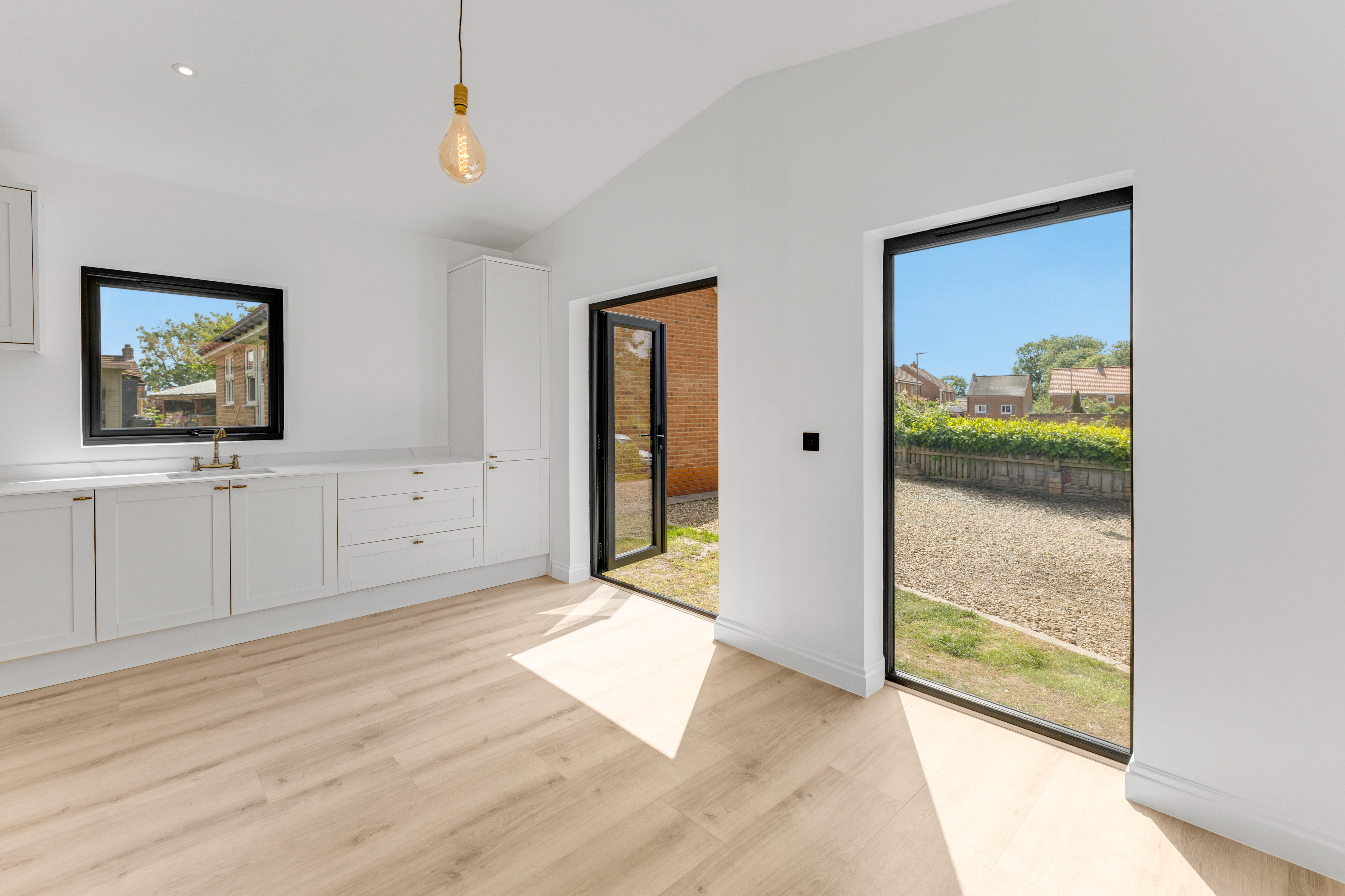 Bespoke garden annexe Interior Design with modern appliances and clean worktops