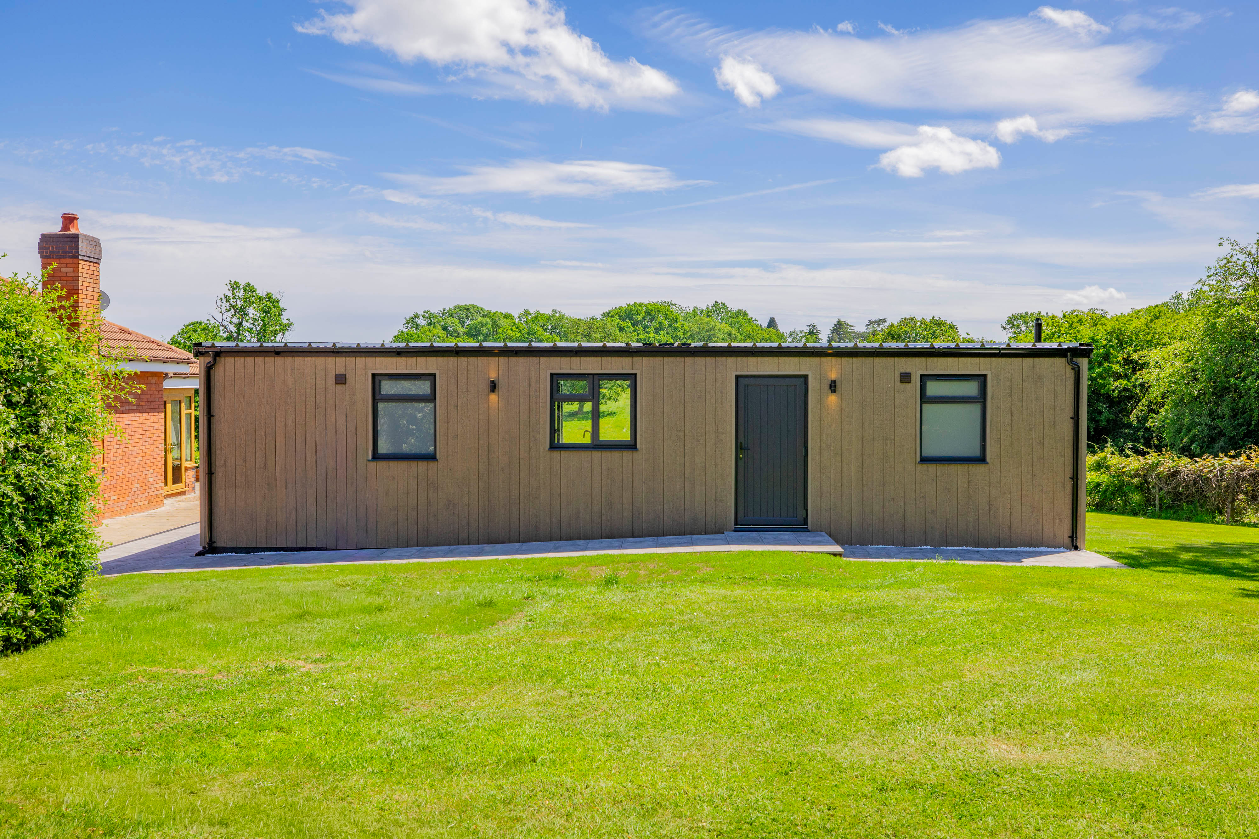 Bespoke garden annexe Exterior Design with modern appliances and clean worktops