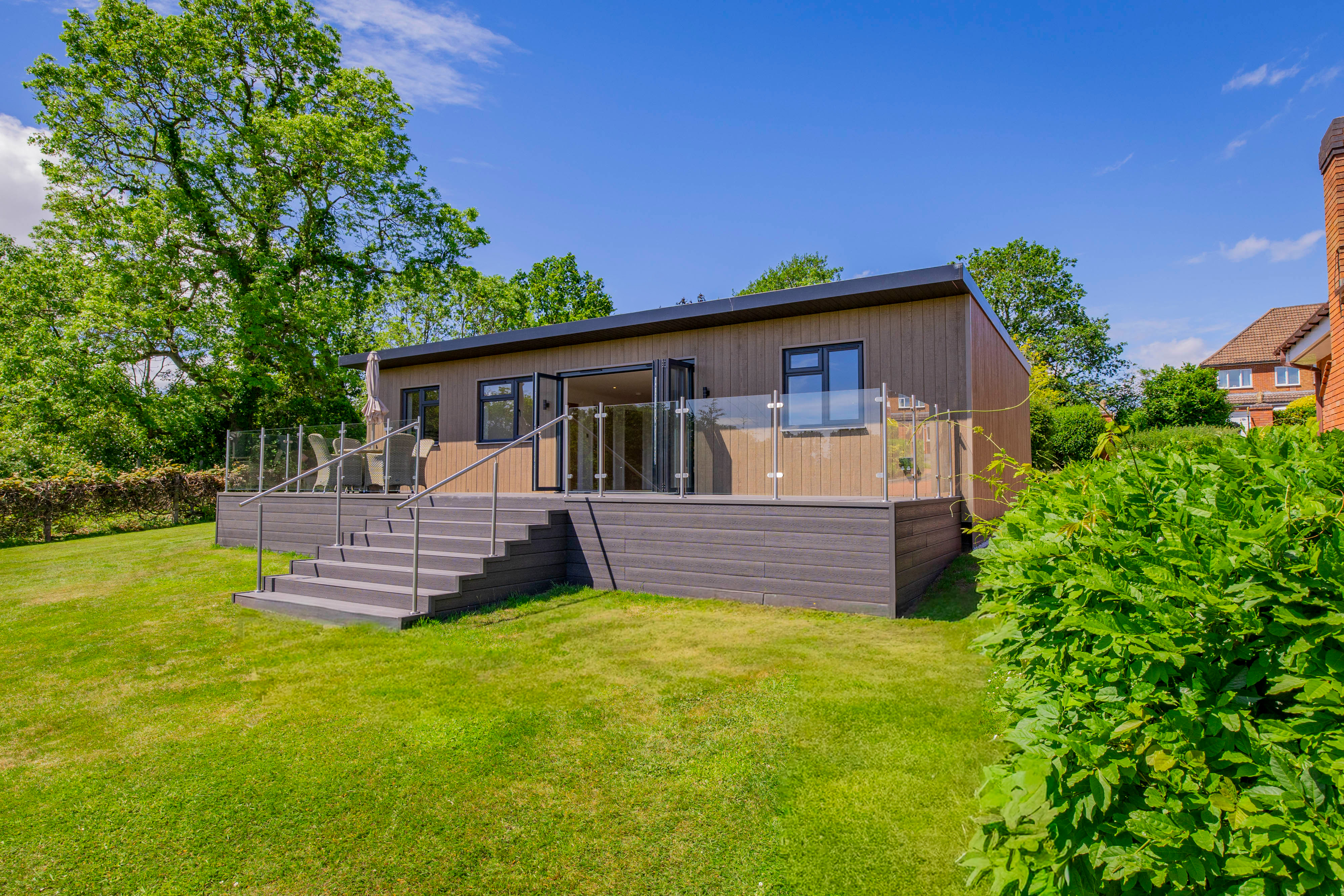 Bespoke garden annexe Exterior Design with modern appliances and clean worktops