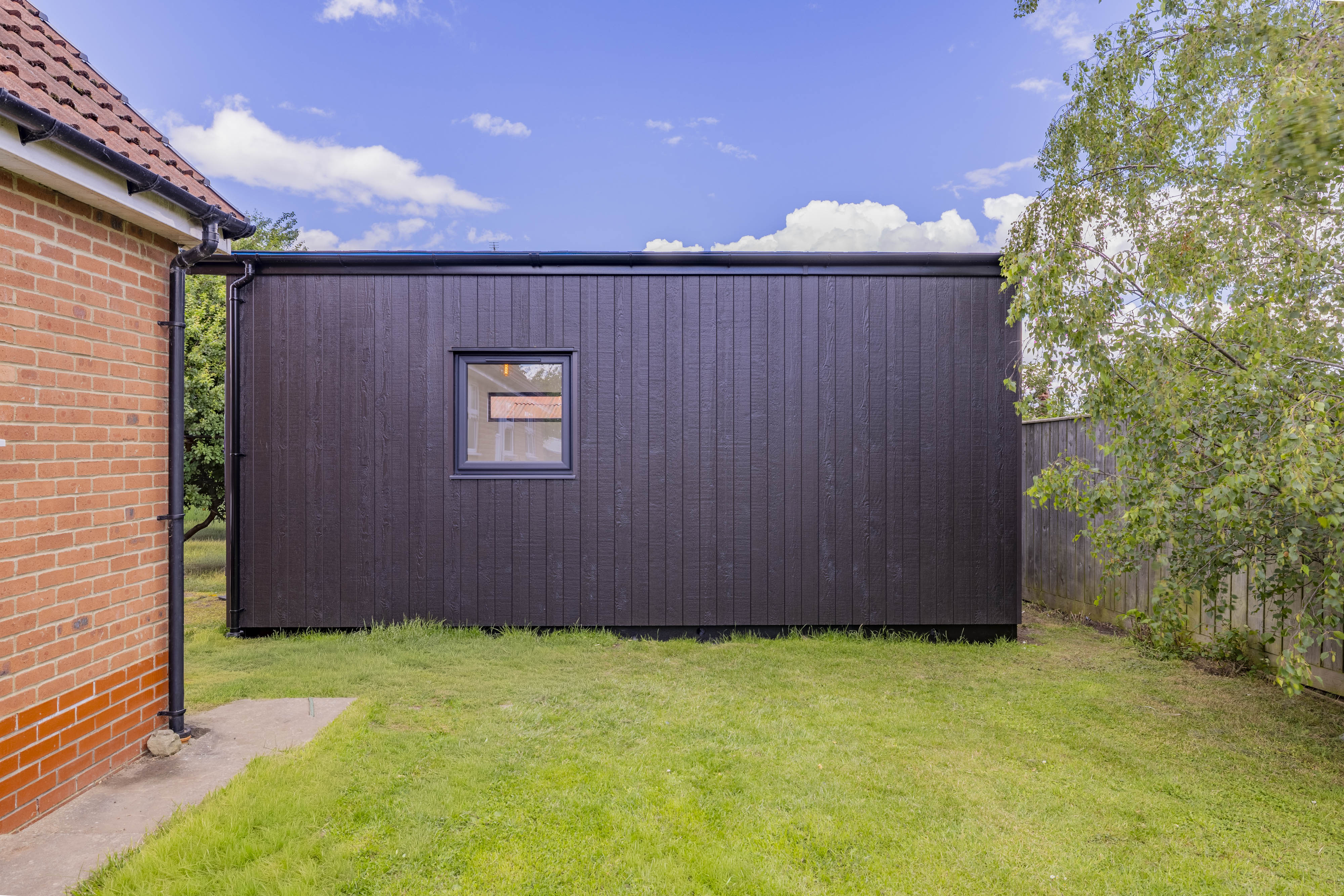 Bespoke garden annexe Exterior Design with modern appliances and clean worktops