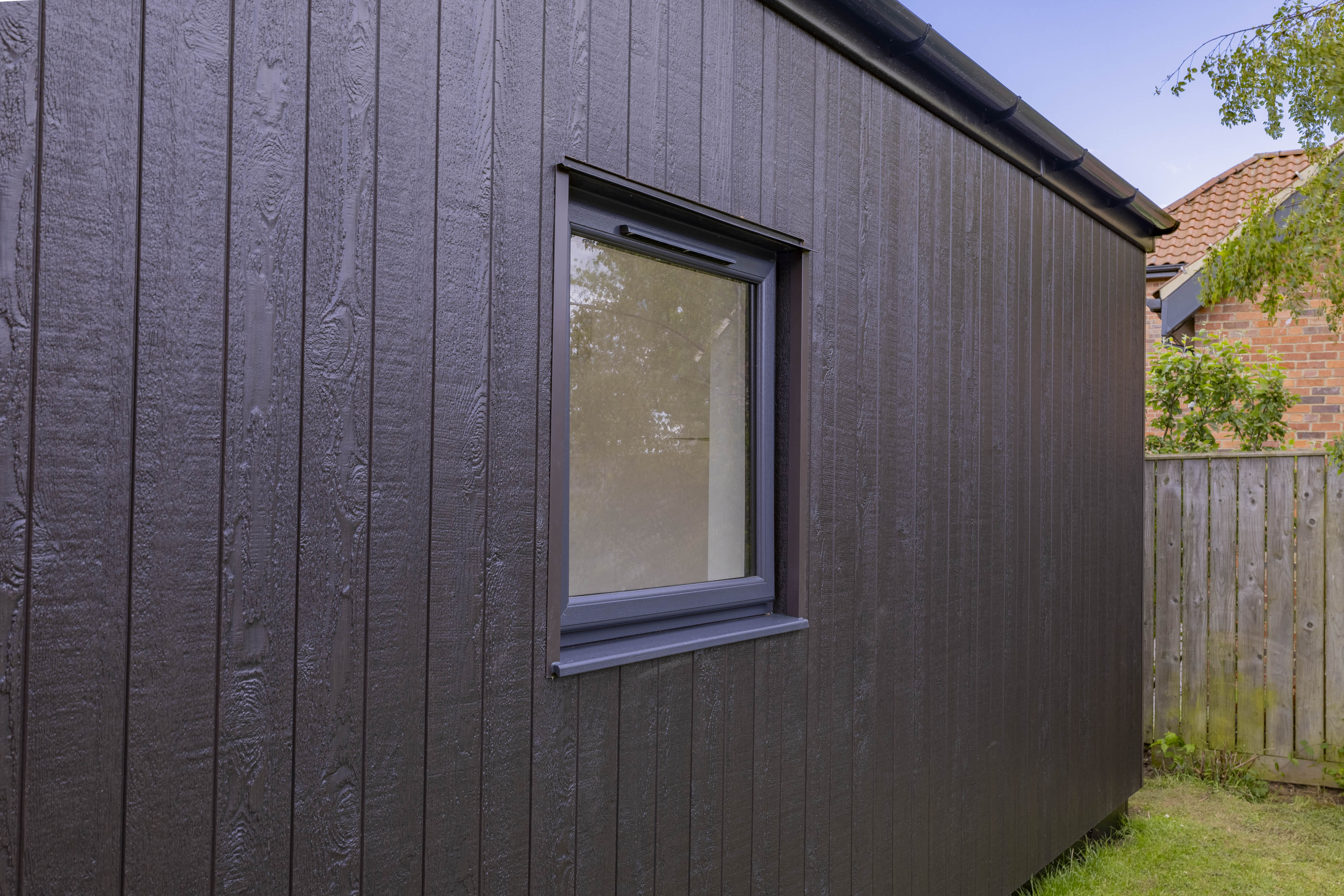 Bespoke garden annexe Exterior Design with modern appliances and clean worktops