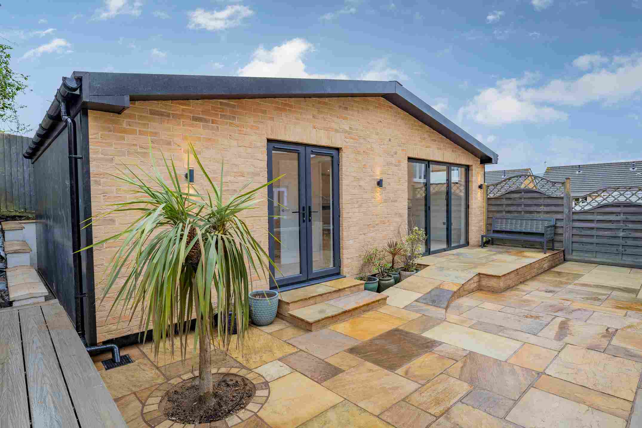 Modern garden annexe kitchen with fitted cabinets and compact layout